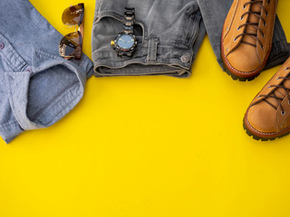 Men fashion clothing set and accessories isolated on a yellow background. Man clothes concept, Top view