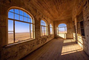 Fototapeta na wymiar Ruins of the mining town Kolmanskop in the Namib desert near Luderitz in Namibia