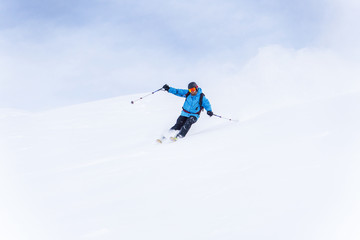 Photo of sports man with beard skiing.