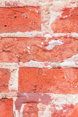 Red grunge brick background. Old brick wall texture of red stone blocks closeup