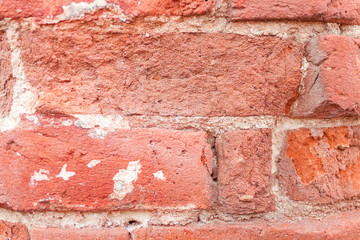 Red grunge brick background. Old brick wall texture of red stone blocks closeup