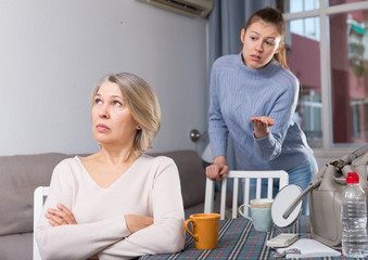 Adult daughter scolds mature mother