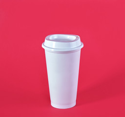 disposable plastic  cup isolated on red background
