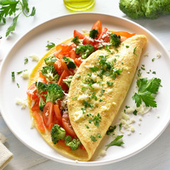 Stuffed omelette with tomatoes, red bell pepper and broccoli