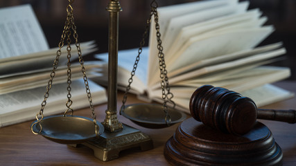 Law and Justice concept. Mallet of the judge, books, scales of justice. Courtroom theme.