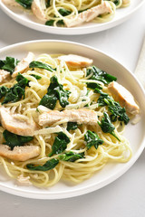 Spaghetti with spinach leaves, grilled chicken breast and cheese