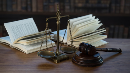 Law and Justice concept. Mallet of the judge, books, scales of justice. Courtroom theme.