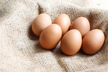 Heap Organic brown Eggs of chicken uncooked freshness  nutrition healthy on brown sack for background texture soft focus close up