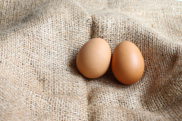 Heap Organic brown two Eggs of chicken uncooked freshness  nutrition healthy on brown sack for background texture soft focus close up