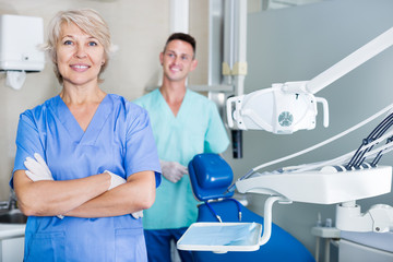 Dentist standing in dental office with hands crossed