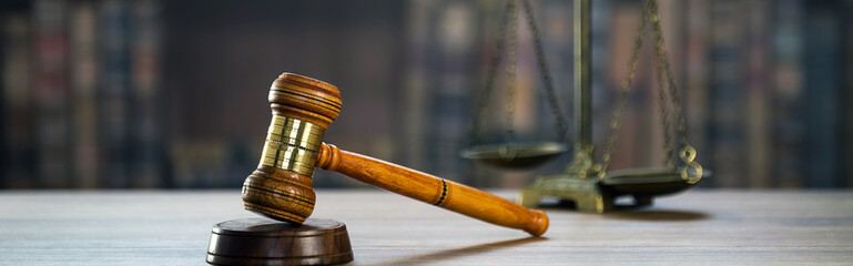 Law and Justice concept. Mallet of the judge, books, scales of justice. Courtroom theme.