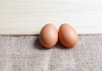 Organic brown Eggs of chicken uncooked freshness  nutrition healthy on brown sack and wood  for background texture soft focus close up