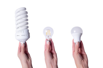 Woman hand holding energy saving lamp, iso