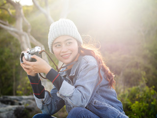 Happy Asian woman vintage camera with nature background, camping concept.