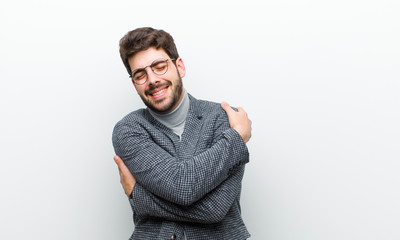 young manager man feeling in love, smiling, cuddling and hugging self, staying single, being...
