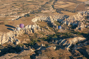 Aerial view of the rocks and balloons near G&ouml;reme, Open air UNESCO world heritage site Museum in Cappadocia, Turkey