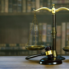 Law and Justice concept. Mallet of the judge, books, scales of justice. Courtroom theme.