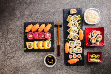  Sushi Set Sashimi und Sushirollen auf Steinschiefer serviert