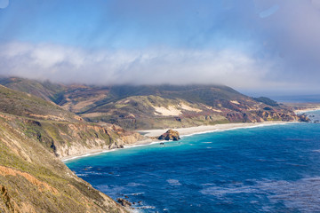 coast in big sur with Point Sur Light at horizon