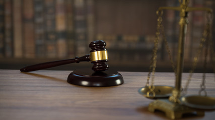 Law and Justice concept. Mallet of the judge, books, scales of justice. Courtroom theme.