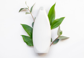 Natural organic cosmetic packaging plastic mock up with leaves. Mock-up bottle for branding.