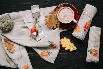 View from above on table with linen kitchen towels and coffee cup. Table setting. Stylish autumn flat lay. fall home decoration