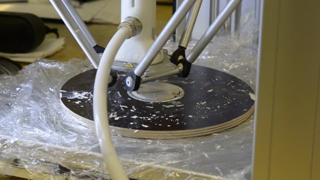 Turin, Piemonte, Italy. October 2019. At a coworking tool box a 3D printer demo and ceramic extrusion. The head deposits small amounts of material with rapid movements. Selective focus.