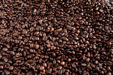 Roasted coffee beans background, arabica and robusta.