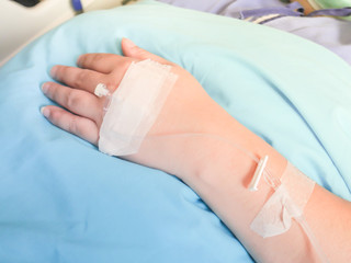 patient in hospital with saline intravenous (iv), saline into the body for treatment