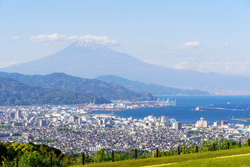 Fuji Mountain and seascape view background, famous landmark of Shimizu port, Suruga Bay on sunny day, clear blue sky and Blue Ocean in Shizuoka city, Japan.