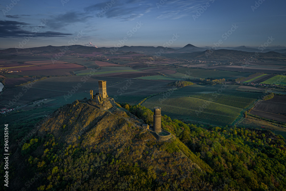 Wall mural At the top of the mountain there is the ruin of a mediaeval castle, of which two towers and some wall fragments are still standing