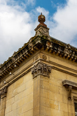 The building of the old Baths in Spa, Belgium, exterior architectural detail against the cloudy sky