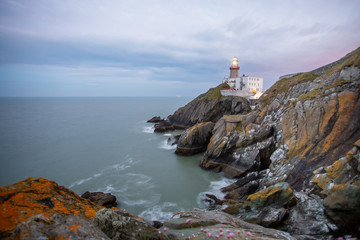 Fototapeta na wymiar Howth Lighthouse in middle of the storm. Moody weather and calm wind.4