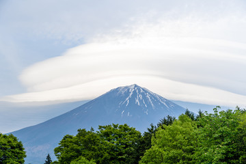 Mount Fuji with cloudy hat on top , vertical close up with amazing clouds on blue sky background, beautiful in morning time in Fujinomiya, Shizuoka ,Japan