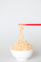 close up noodle with red chopstick hand holding 