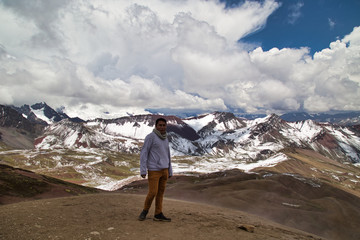 Man with panoramic view. Hiking scene in Vinicunca, Cusco region, Peru. Montana of Seven Colors, Rainbow Mountain