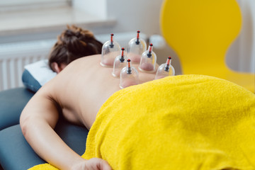 Session in the physical therapy with cupping