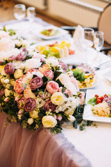 The decor of the wedding dinner. Wedding table setting. Dishes on the table in a restaurant.