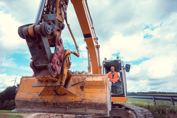 Construction worker operating the crawler excavator