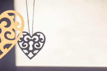 Shadow of the wooden ornament heart on white background. Love and Valentine's day holidays celebration concept with copy space.