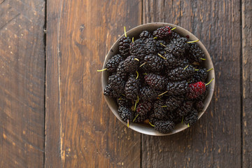 Ripe and fresh fruit of black mulberry, healthy food of juicy mulberry fruit. Close-up, the texture of the berries on the full frame
