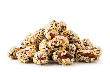 Almond covered sesame seeds on a white background. Isolated.