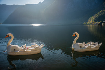 lake Hallstatt with white Swan boat for tourists and kids