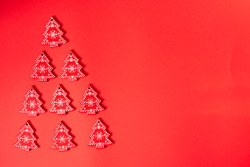 Festive little red christmas trees with white ornament over the red background with copy space for text and xmas decoration. mockup
