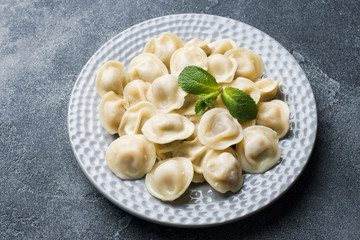 Dumplings stuffed with meat, ravioli, dumplings. Dumplings with stuffing. Russian cuisine.
