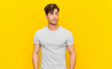  with a worried, confused, clueless expression, looking up to copy space, doubting