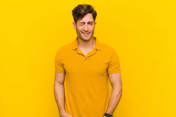  looking happy and friendly, smiling and winking an eye at you with a positive attitude
