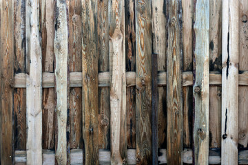 Close up of gray old wooden fence panels.