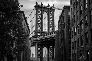Naklejka premium View of one of the towers of the Manhattan Bridge from the streets of the DUMBO district, Brooklyn, NYC black and white