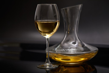 A glass full of wine and wine decanters